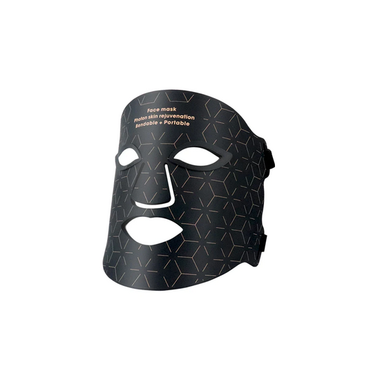 A black face mask with a geometric pattern and a digital device attached, indicating the Photon Skin Rejuvenation Instrument.